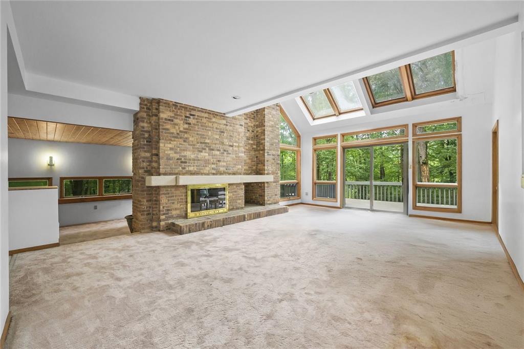 958 Blackburn Road Sewickley, PA 15143 - Photo 13 of 49 a view of an empty room with a fireplace and a large window