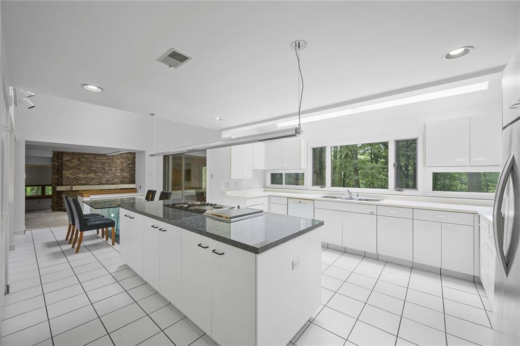 958 Blackburn Road Sewickley, PA 15143 - Photo 23 of 49 a kitchen with a sink dining table and chairs