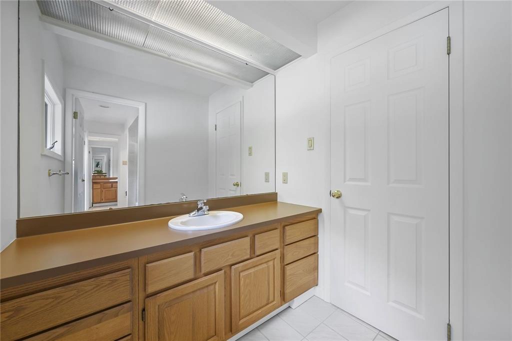 958 Blackburn Road Sewickley, PA 15143 - Photo 37 of 49 a bathroom with a granite countertop sink and a mirror