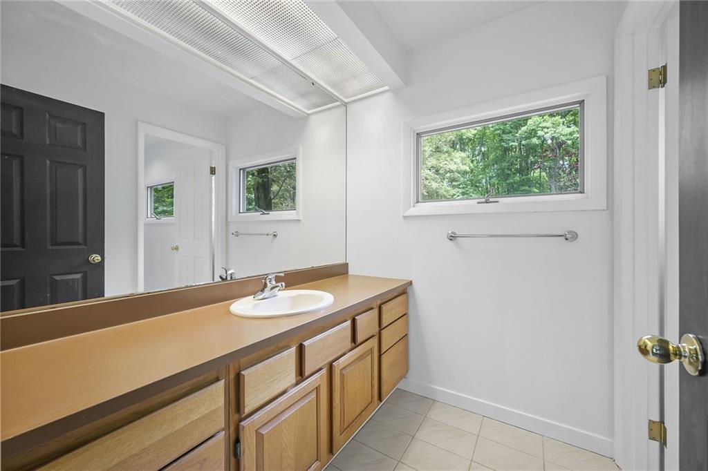 958 Blackburn Road Sewickley, PA 15143 - Photo 39 of 49 a bathroom with a granite countertop sink and a mirror