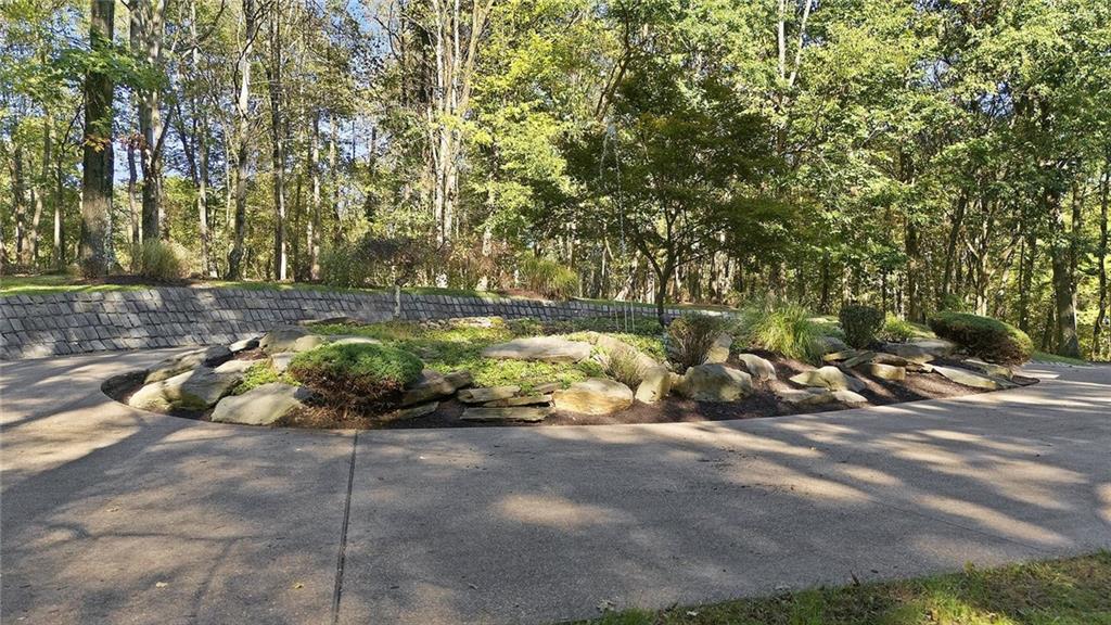 958 Blackburn Road Sewickley, PA 15143 - Photo 4 of 49 a view of a garden with a bench