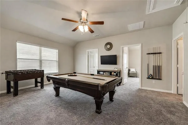 a living room with furniture a flat screen tv and a window