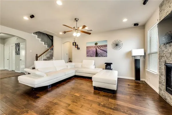 a living room with furniture and a chandelier