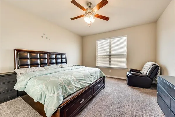 a bedroom with a bed couch and window