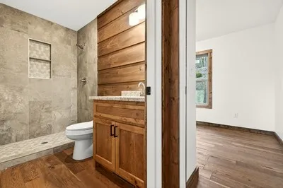 a bathroom with a toilet and a shower