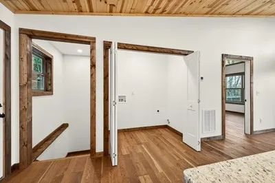 a view of a room with wooden floor and front door