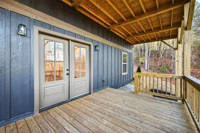 a view of a porch with wooden floor and entrance