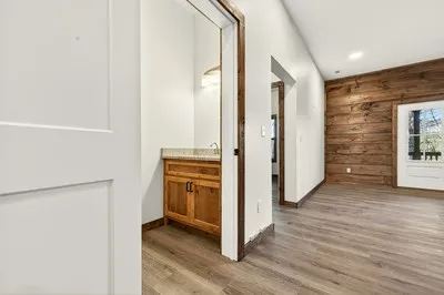 a view of a hallway with wooden floor