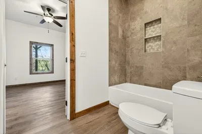 a bathroom with a toilet a sink and shower