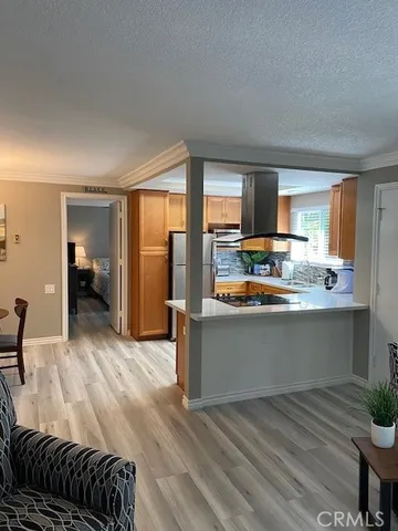 a living room with a bed furniture and a large window