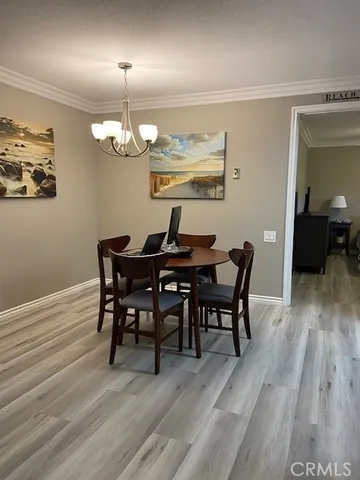 a view of a dining room with furniture wooden floor and chandelier