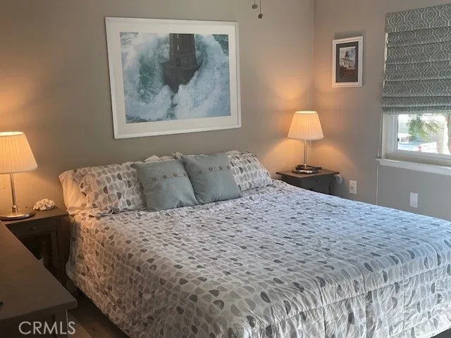 a bedroom with a bed and a lamp