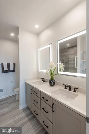 a bathroom with a double vanity sink and a mirror