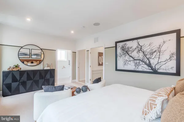 a bedroom with bed and a painting