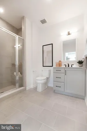 a bathroom with a toilet sink and a mirror