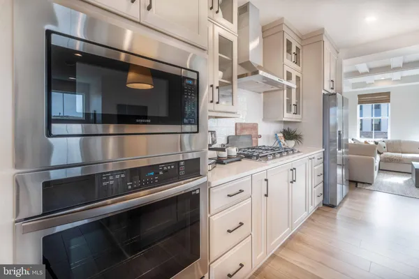a kitchen with stainless steel appliances and cabinets