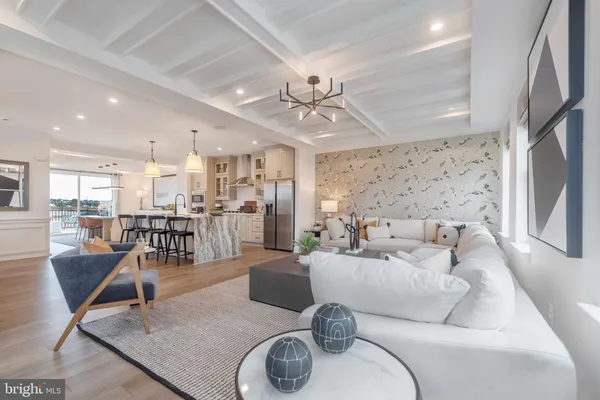 a living room with furniture and a dining table with kitchen view