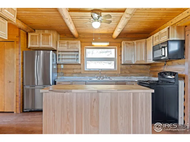 a kitchen with stainless steel appliances granite countertop a refrigerator and a stove