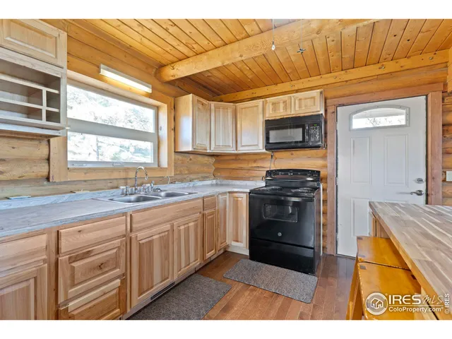 a kitchen with granite countertop a stove sink and cabinets
