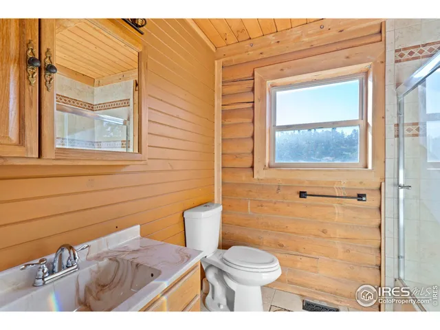 a bathroom with a toilet a sink and a window