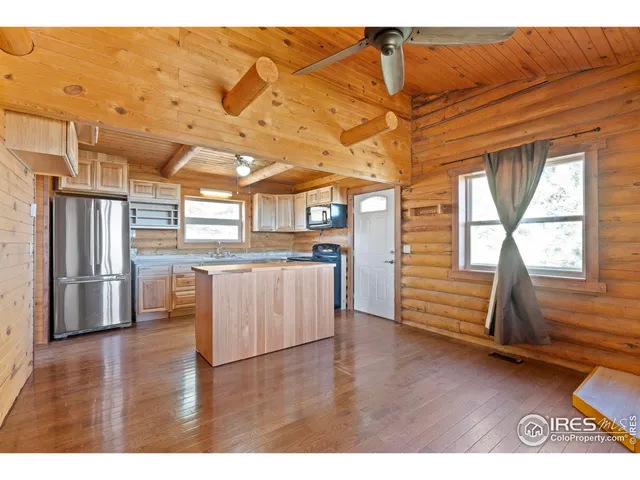 a view of a room with wooden floors