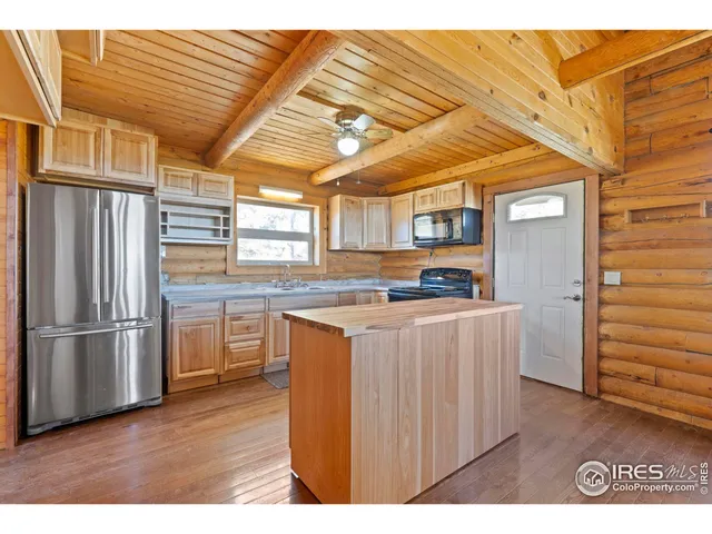 a kitchen with stainless steel appliances granite countertop a refrigerator and a stove