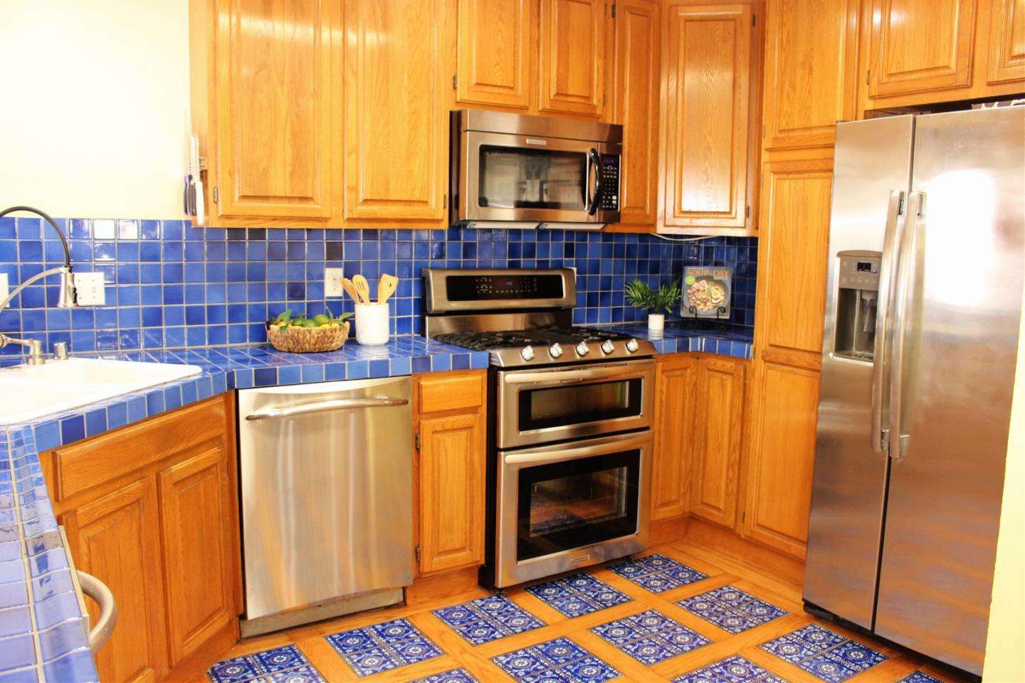 774 Prairie Creek Drive Pacifica, CA 94044 - Photo 13 of 29 a kitchen with stainless steel appliances a stove a sink and a microwave