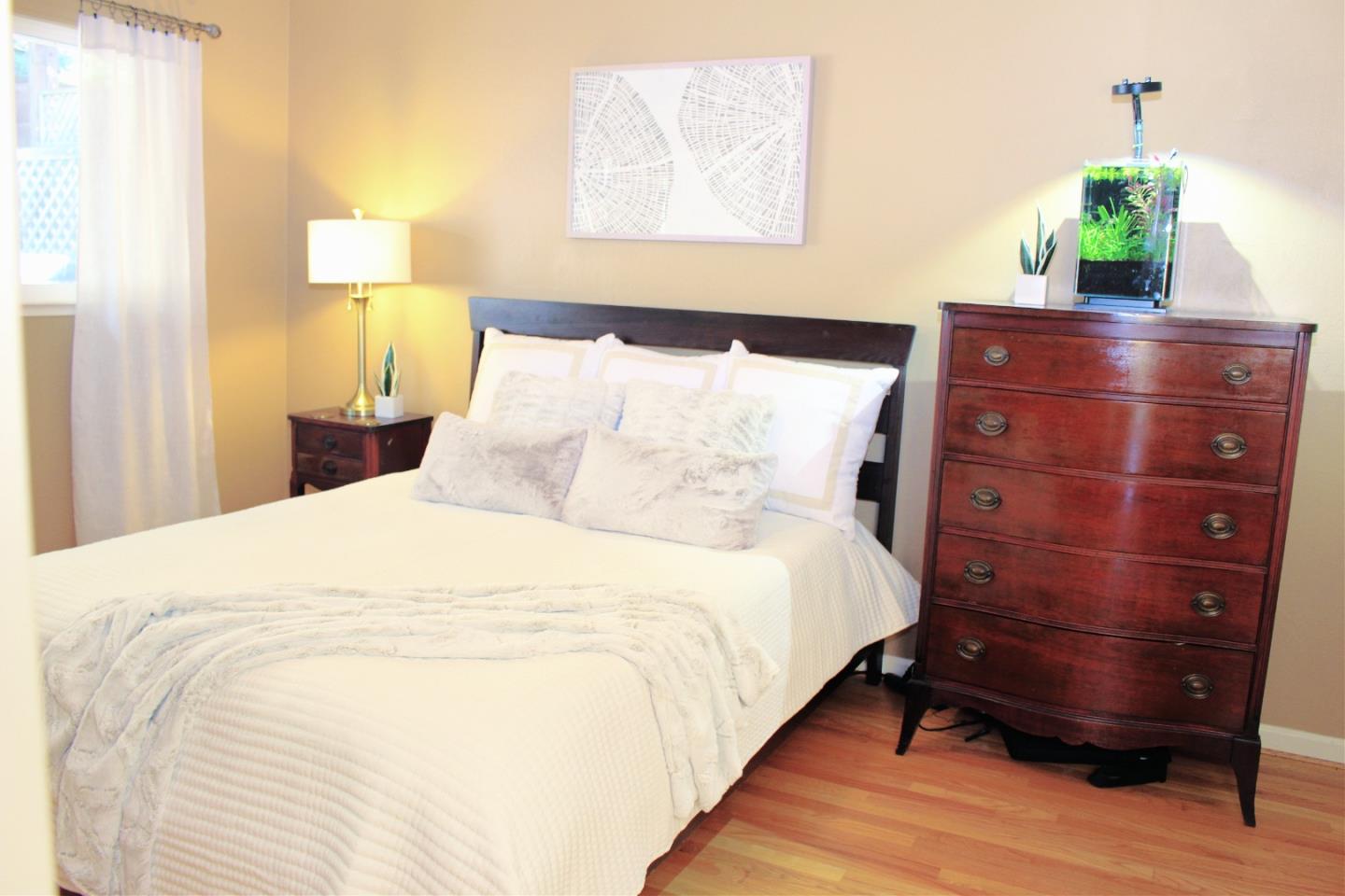 774 Prairie Creek Drive Pacifica, CA 94044 - Photo 17 of 29 a bedroom with a bed and a potted plant