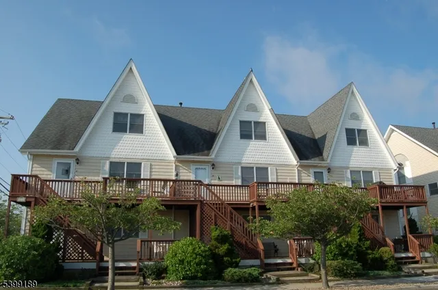 a view of house with yard and utility room