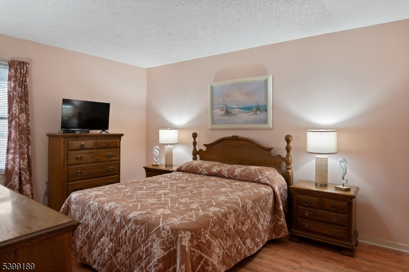 111 K Street, Unit A2 Seaside Park, NJ 08752 - Photo 11 of 15 a bedroom with a bed and a flat screen tv