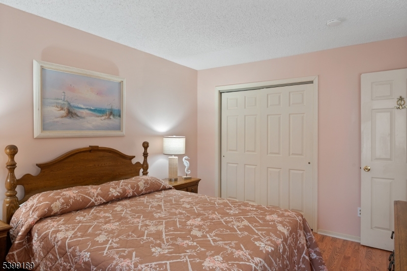 111 K Street, Unit A2 Seaside Park, NJ 08752 - Photo 12 of 15 a bedroom with a bed and a painting on the wall