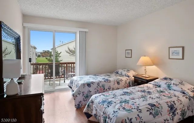 a bedroom with two large bed and a window