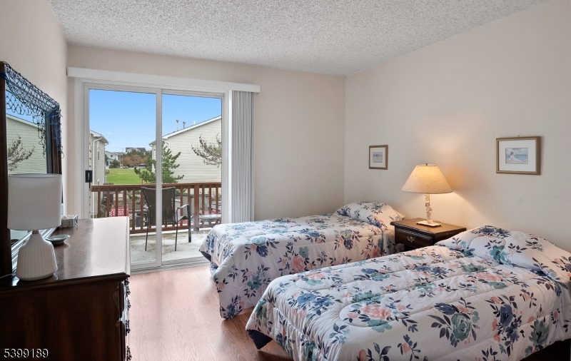111 K Street, Unit A2 Seaside Park, NJ 08752 - Photo 13 of 15 a bedroom with two large bed and a window