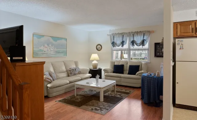 a living room with furniture a lamp and a flat screen tv