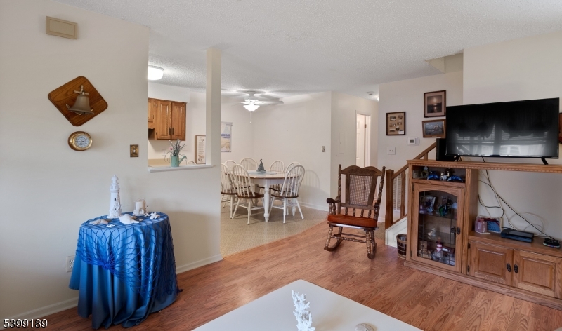 111 K Street, Unit A2 Seaside Park, NJ 08752 - Photo 7 of 15 a living room with furniture a flat screen tv and a fireplace