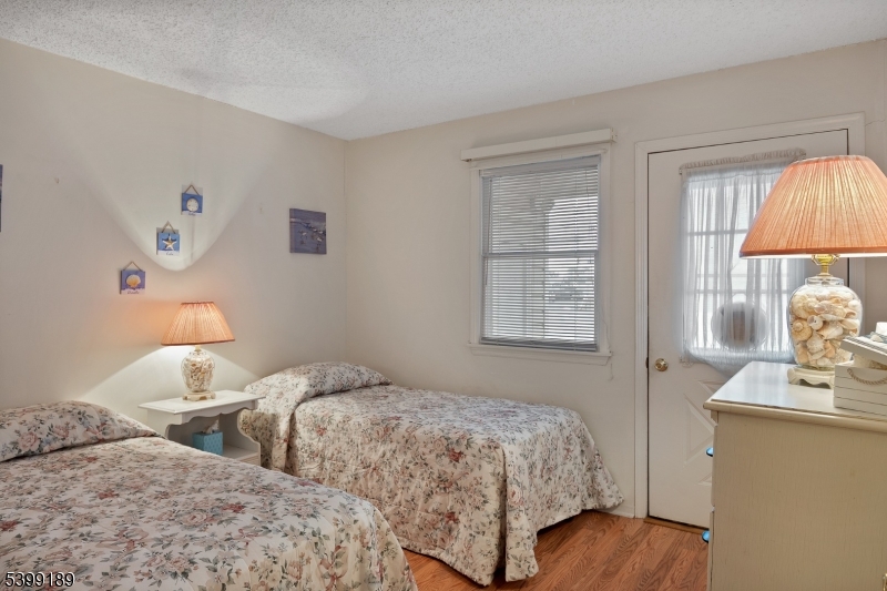 111 K Street, Unit A2 Seaside Park, NJ 08752 - Photo 9 of 15 a bedroom with two beds and a window
