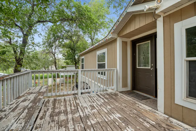 a view of deck with wooden floor and fence next to a yard