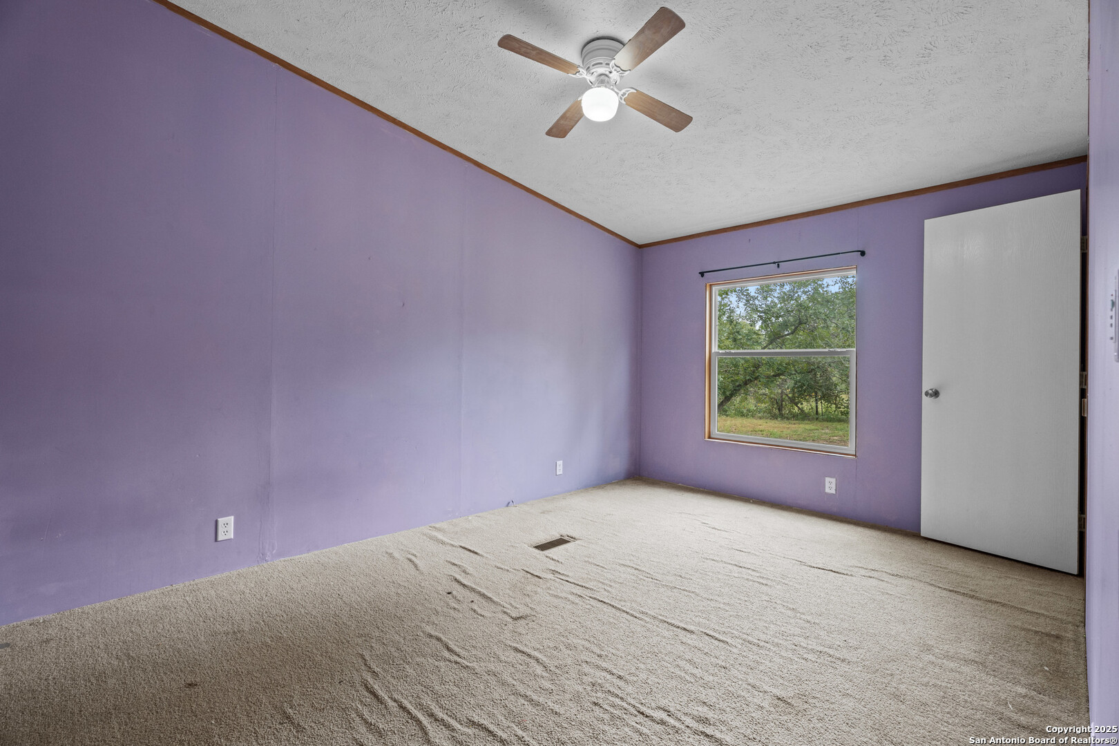 1100 Big Leaf Road San Antonio, TX 78264 - Photo 16 of 26 an empty room with a window and a fan