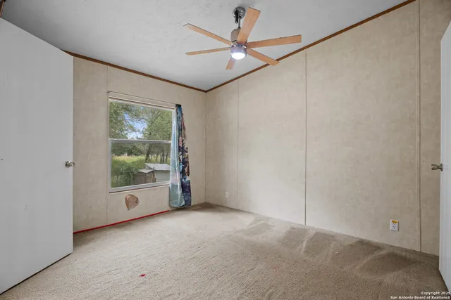 an empty room with windows and closet