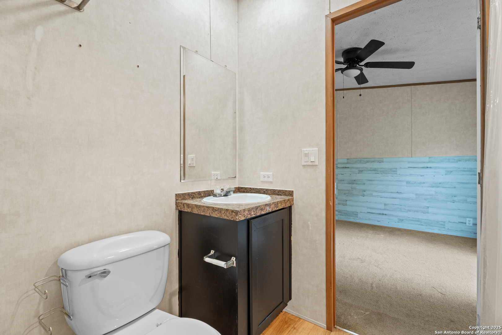 1100 Big Leaf Road San Antonio, TX 78264 - Photo 21 of 26 a bathroom with a granite countertop sink toilet and mirror