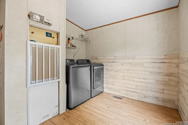 a view of a bedroom with wooden floor