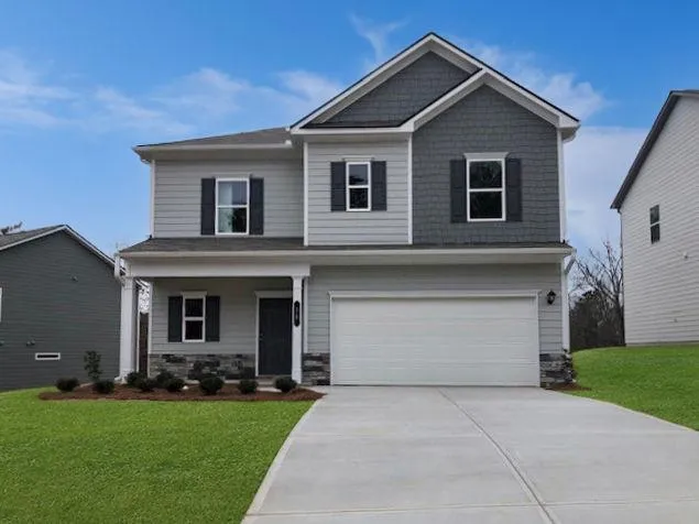 a front view of house with yard and green space