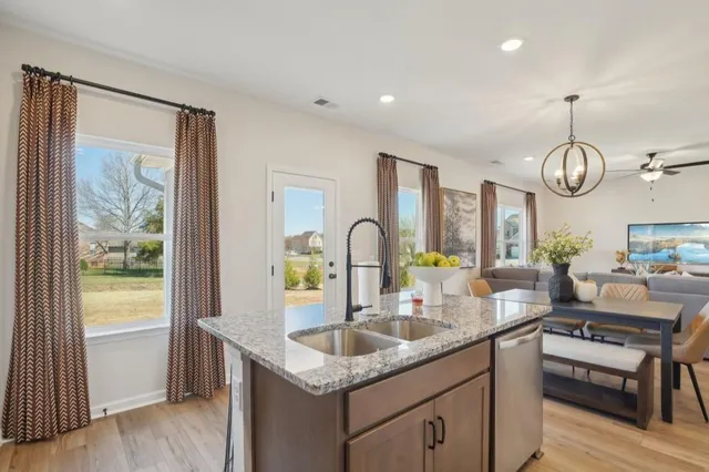 a kitchen with living room and stove top oven