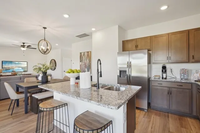 a kitchen with sink refrigerator and cabinets