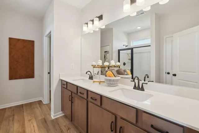 a bathroom with a sink double vanity granite and a mirror