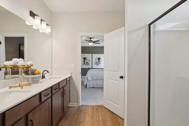 a en suite bathroom with a double vanity sink and a mirror