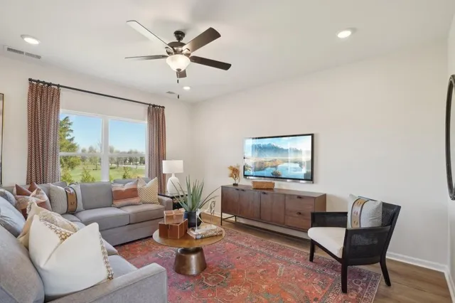 a living room with furniture and a large window