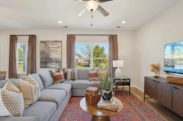 a living room with furniture and a large window