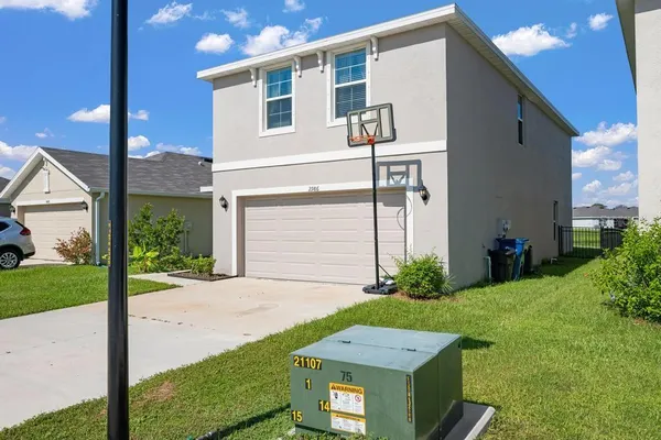 a view of a house with backyard and garden