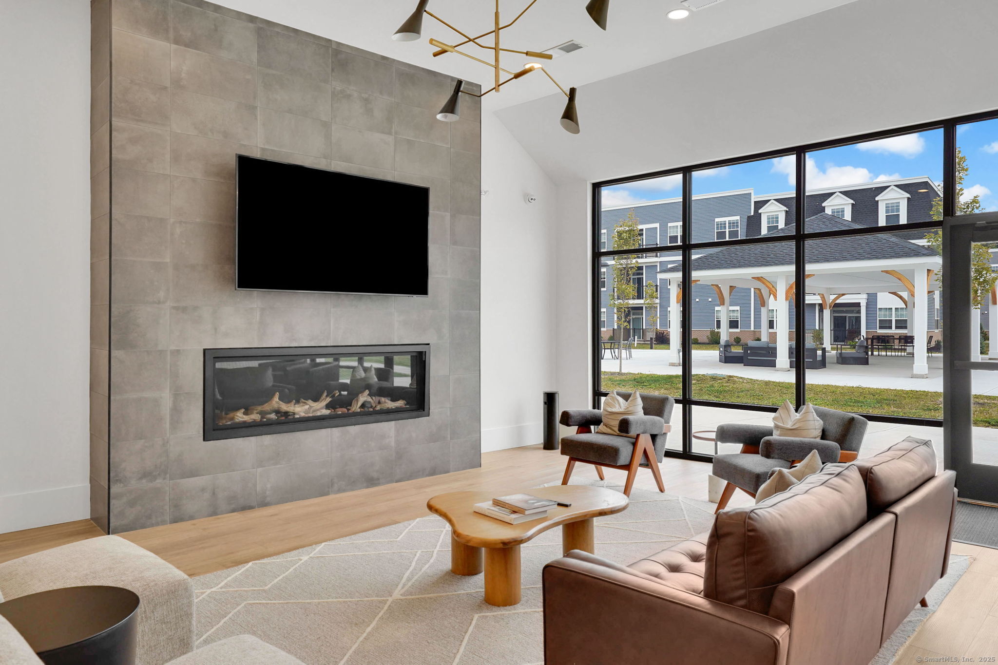 280 Salmon Brook Street, Unit 4311 Granby, CT 06035 - Photo 23 of 26 a living room with furniture a flat screen tv and a fireplace